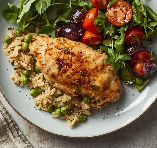 Chicken breast stuffed with peas, rice, and salad
