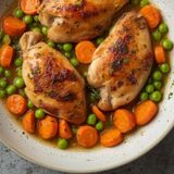 Chicken fillets with carrots and peas